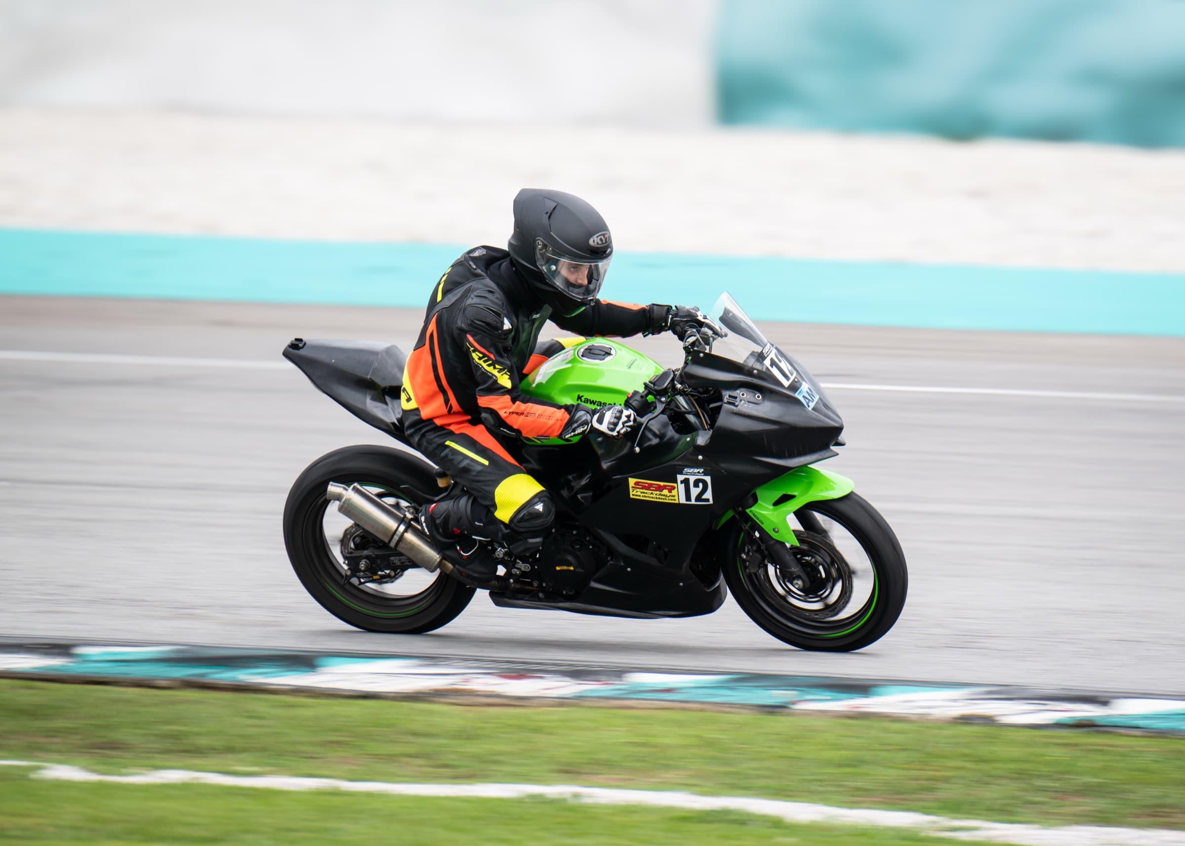 Riders streaming out of the pit lane at Sepang